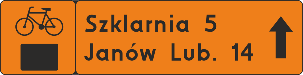 Znak szlaku rowerowego: pomarańczowy prostokąt podzielony na dwie części. Z prawej kwadrat z rowerkiem i czarnym prostokątem na dole, z prawej prostokąt z napisem: Szklarnia 5, Janów Lub. 14 i czarna strzałką na wprost